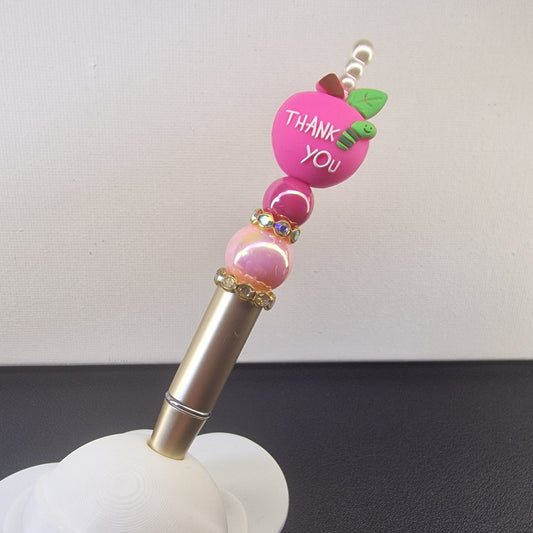 Handversierde goudkleurige pen met fuchsia appel en 'Thank you Teacher'
