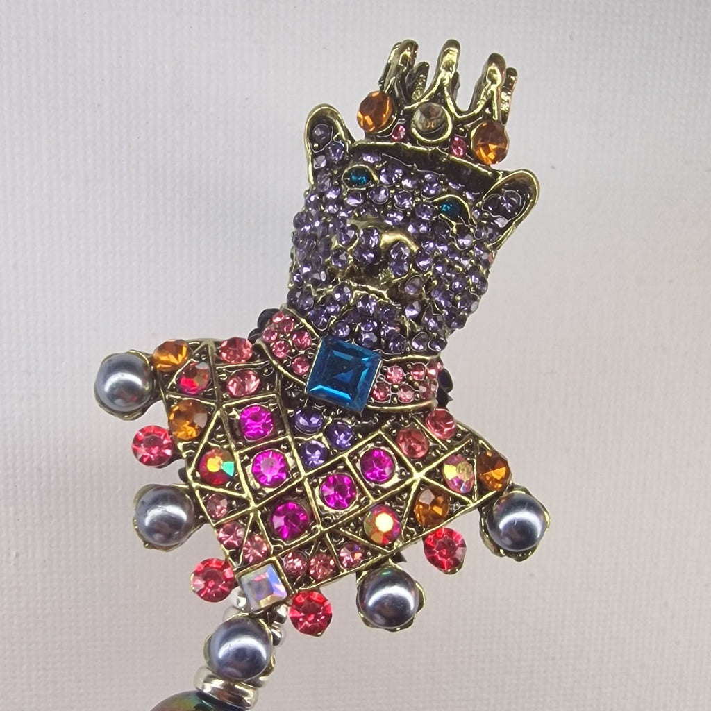 Handversierde zwarte pen met kleurrijke beer en kroon bezet met strass – detailfoto
