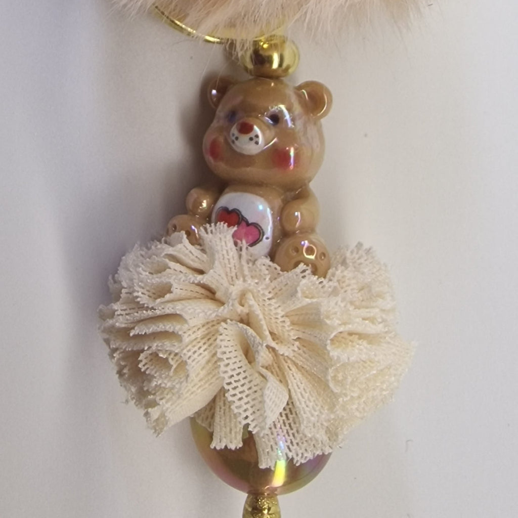 Goudkleurige sleutelhanger met beertje en pompon